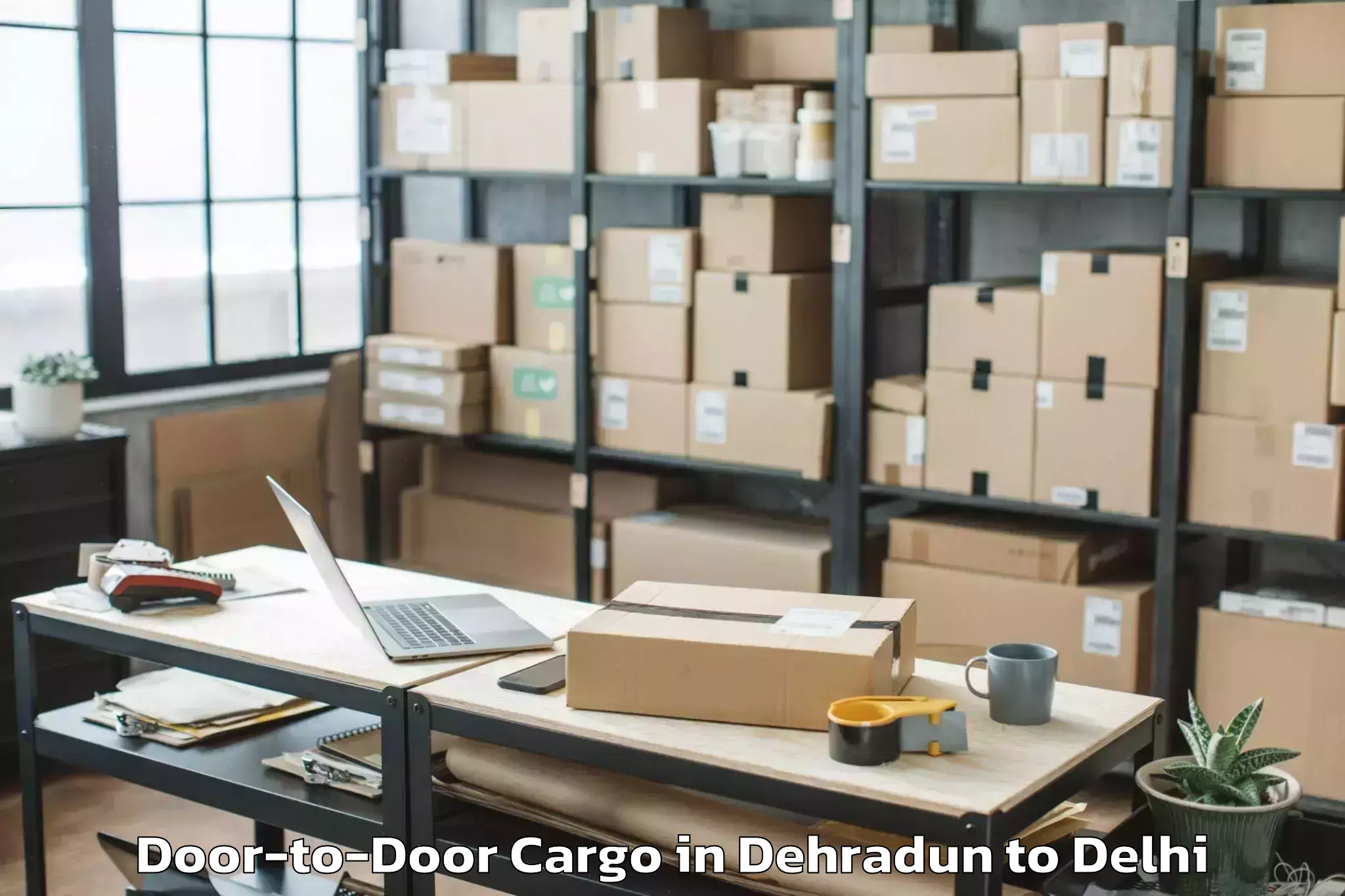 Dehradun to Naraina Industrial Estate Door To Door Cargo